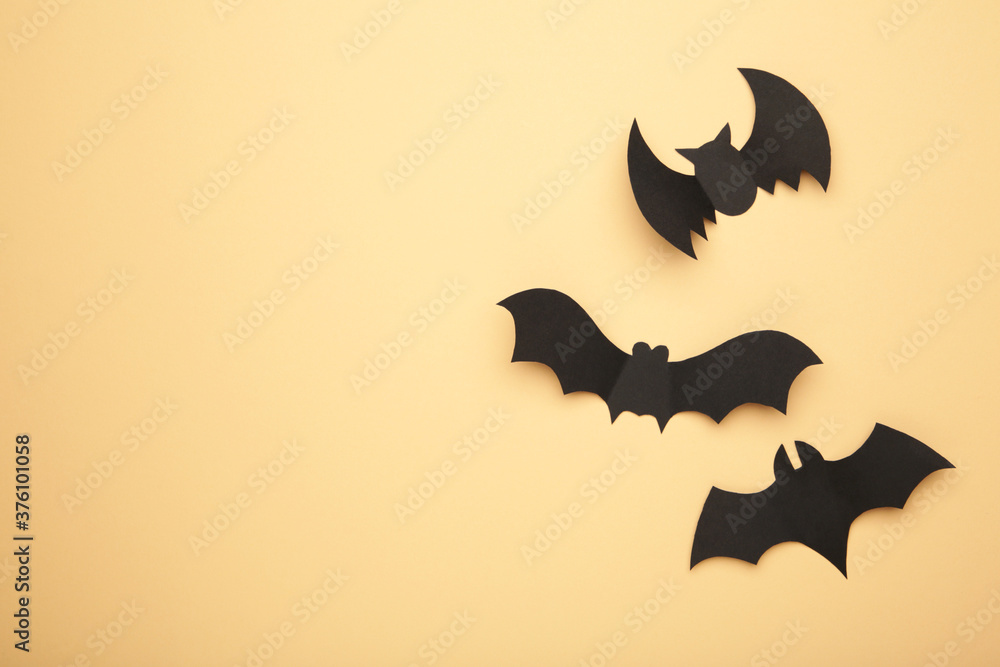 Halloween paper bats on biege background. Halloween concept.