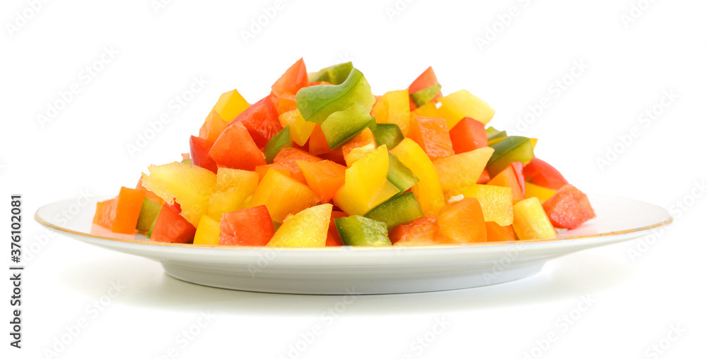Yellow, red and green peppers Bulgarian. Slicing. Cubes in plate on white Yellow, red and green peppers Bulgarian. Slicing. Cubes in plate on white