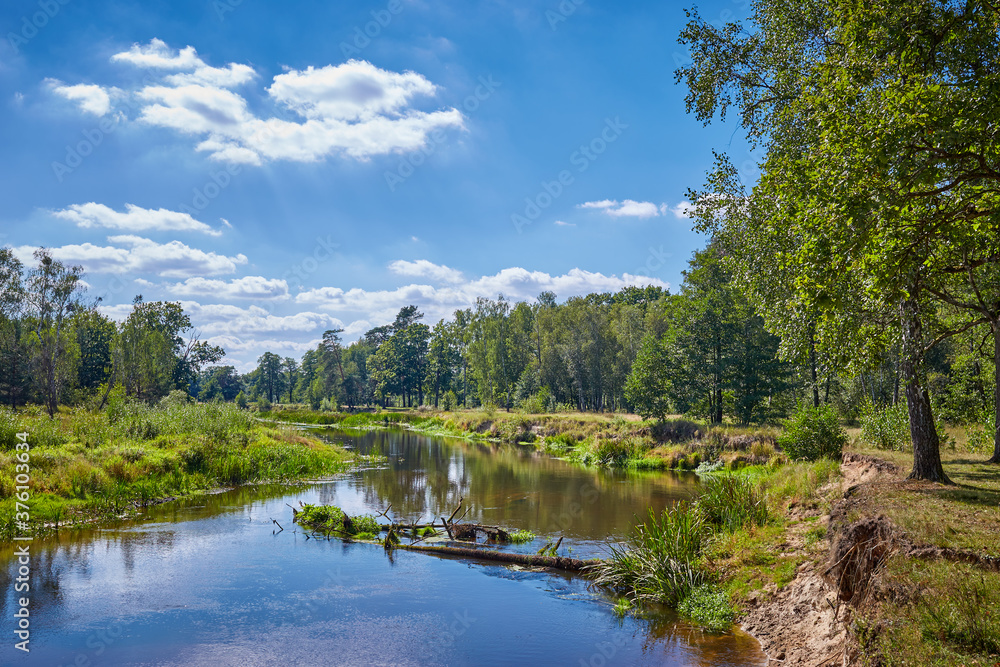Scenic landscape with calm river and green vegetation. Scenic landscape with calm river and green vegetation.