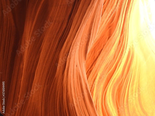 Golden hues due to reflected light in Lower Antelope Canyon. Waves in the sandstone carved by nature.