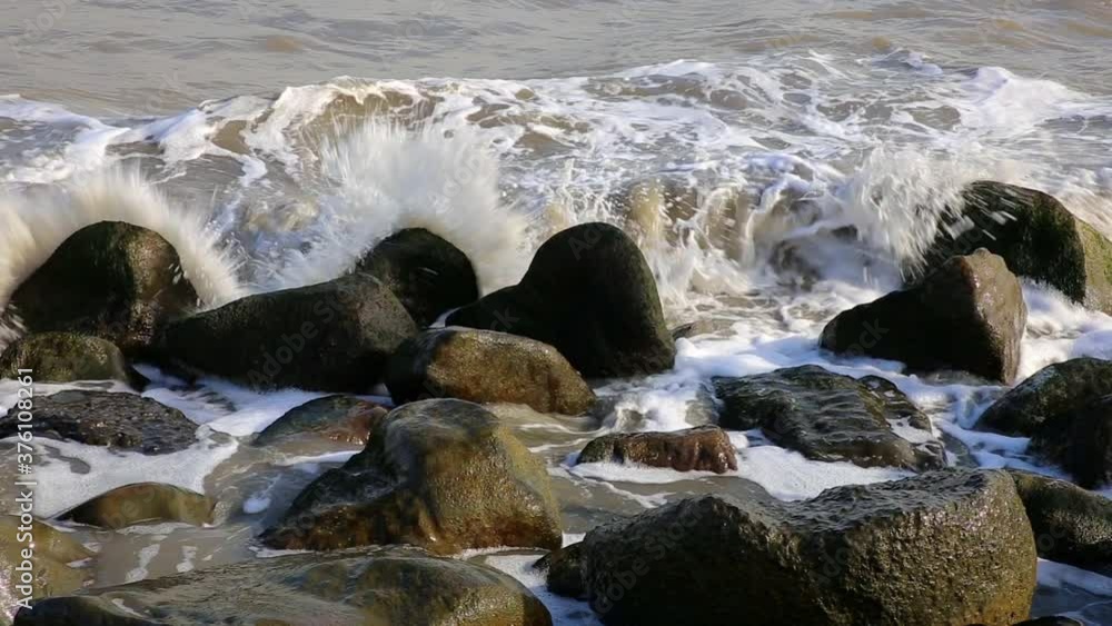 sea waves breaking on coastal stones, Caspian Sea, Iran.
