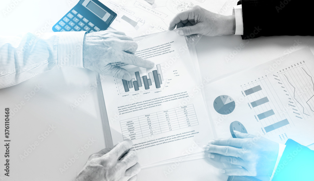 Businesspeople having a discussion about financial report; light effect Businesspeople having a discussion about financial report; light effect