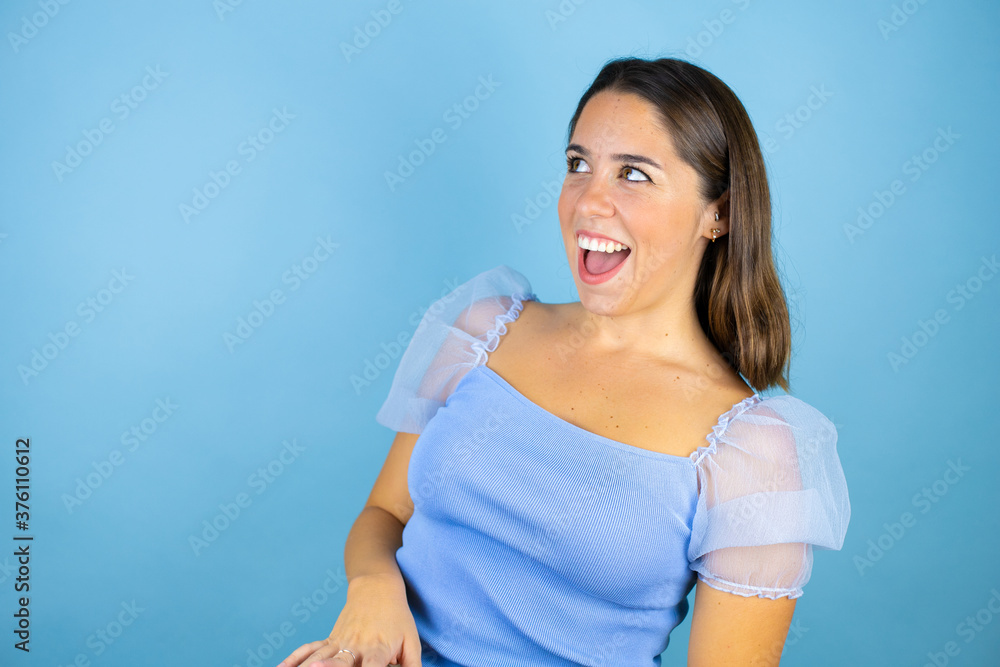 Young beautiful woman over isolated blue background afraid and shocked with surprise expression, fear and excited face. Young beautiful woman over isolated blue background afraid and shocked with surprise expression, fear and excited face.
