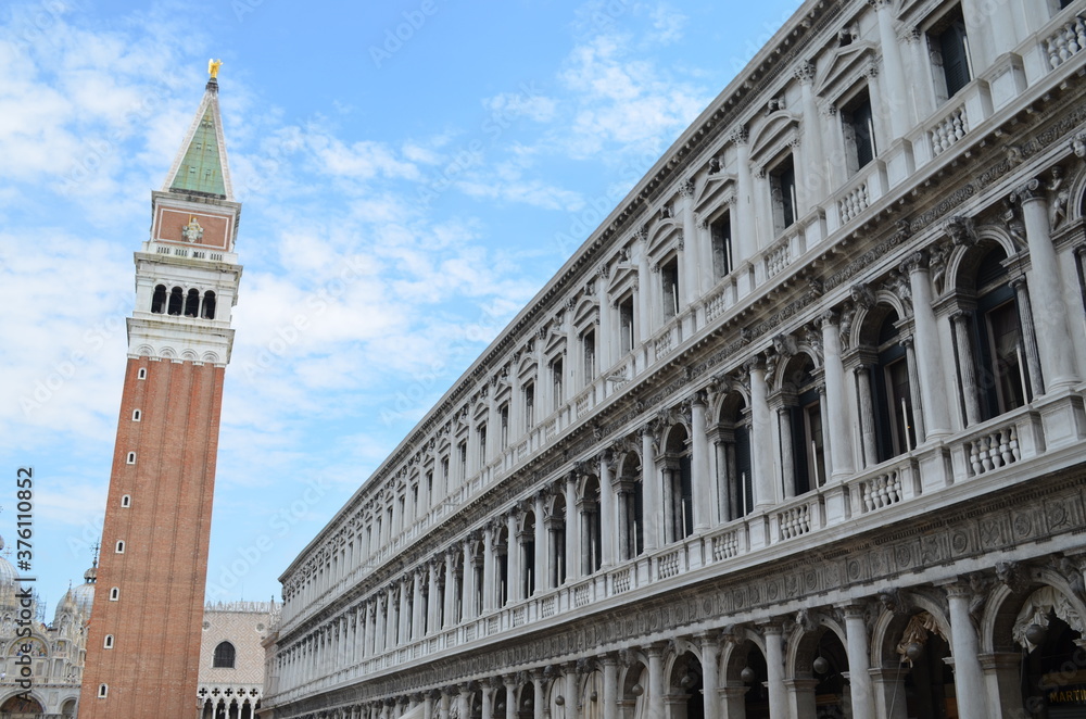 
view of a part of piazza san marco with the bell tower and facade of the side building