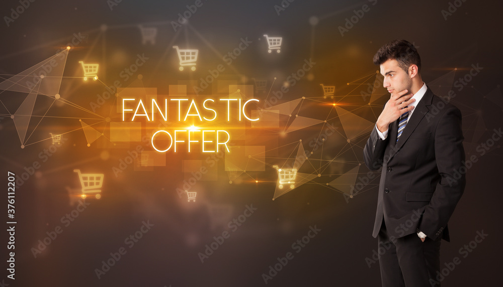 Businessman with shopping cart icons and FANTASTIC OFFER inscription, online shopping concept Businessman with shopping cart icons and FANTASTIC OFFER inscription, online shopping concept