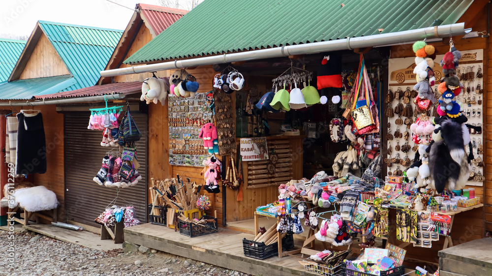 Souvenir market in Yaremche with traditional Carpathian handmade clothing, herbs and wooden tools. Ukrainian textiles, knitted socks, vests, hats. 