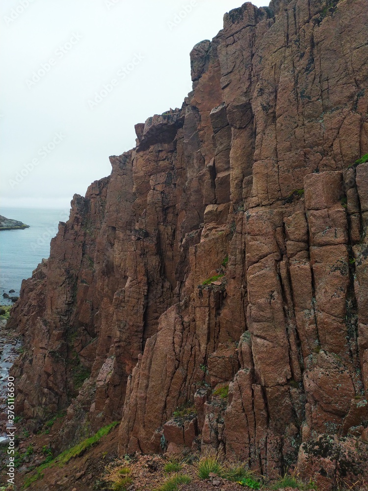 High cliffs and waterfalls on the Barents sea coast of the Arctic ocean