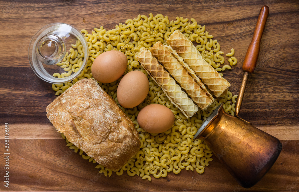 Bakery ingredients - bread, eggs, wafer rolls, Cezve, pasta on wood table. Sweet pastry baking concept. Flat lay, copy space, top view. Bakery ingredients - bread, eggs, wafer rolls, Cezve, pasta on wood table. Sweet pastry baking concept. Flat lay, copy space, top view.