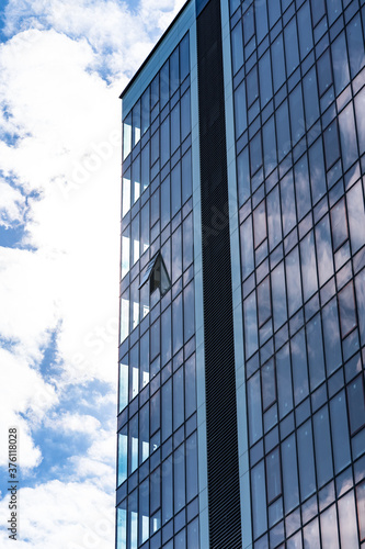 Modern Glass Building Architecture with blue sky and clouds