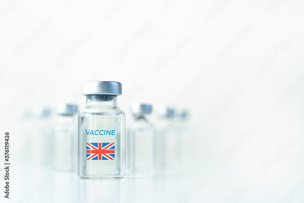 Transparent vials with UK flag. Vaccine for covid-19 coronavirus, flu, infectious diseases. Injection after clinical trials for vaccination of human, child, adult, senior. Medicine, drug concept Transparent vials with UK flag. Vaccine for covid-19 coronavirus, flu, infectious diseases. Injection after clinical trials for vaccination of human, child, adult, senior. Medicine, drug concept