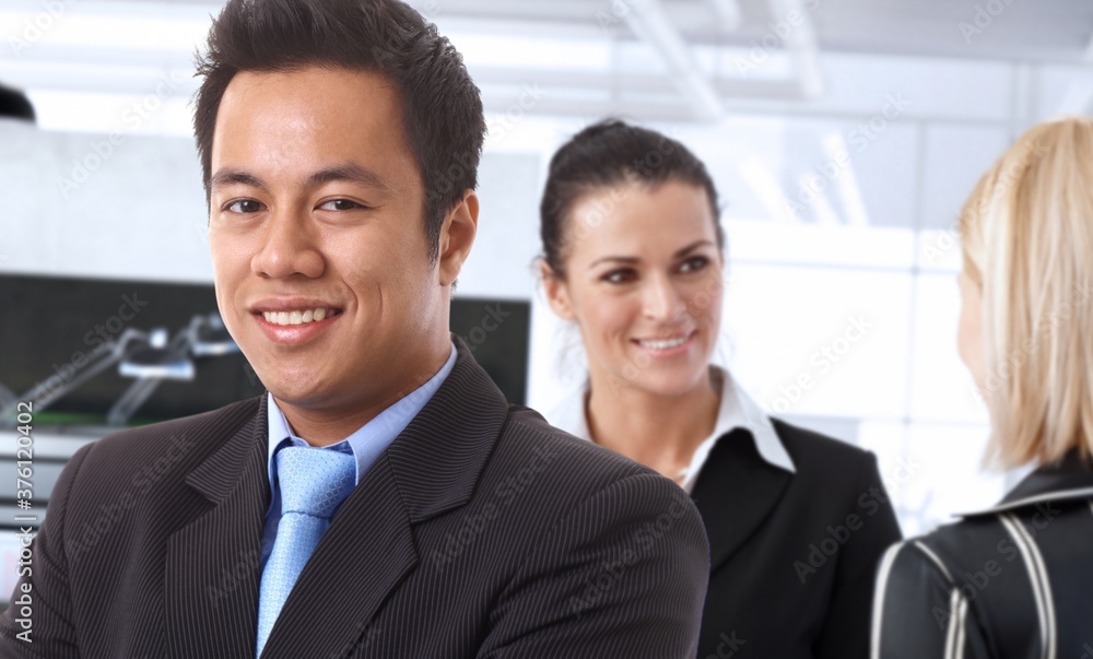 Happy asian businessman in office with colleagues. Happy asian businessman in office with colleagues.
