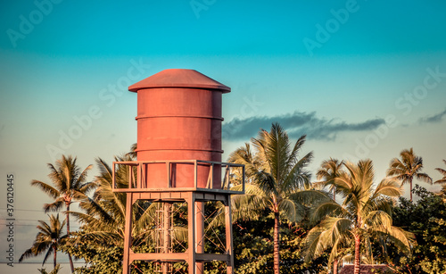 water tower with palm trees in the background in hawaii