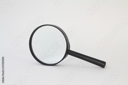 Black magnifying glass (magnifier) isolated on white background. Design element with clipping path. 