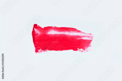 Red colored brush stroke paiting over isolated background,red lipstick smudge