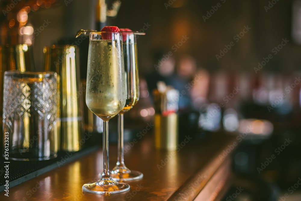 prosecco glasses for two standing on a bar stand