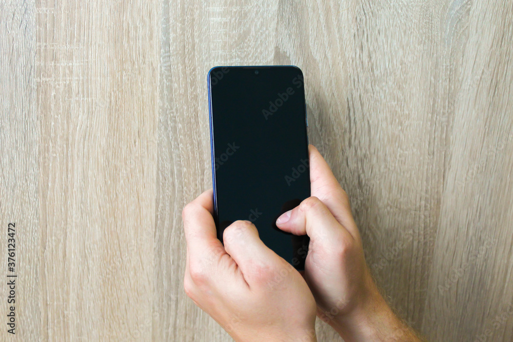 Mobile phone in male hands. Gadget in hand