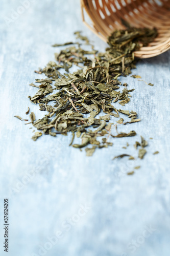 Dried Green Tea Leaves on Bright Background. Close up. 