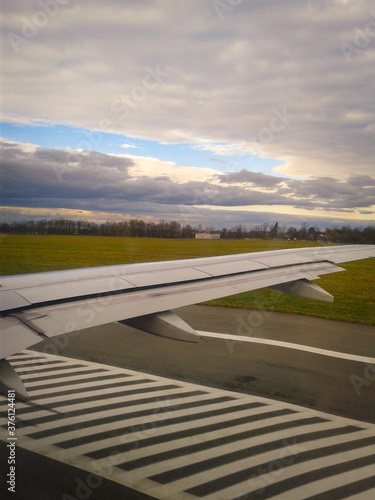 View Of The Runway And The Wing Of The Plane Through The Porthole