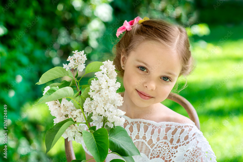 Little girl with white lilac flowers. Little girl with white lilac flowers.