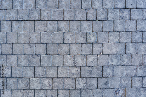 Cobblestone pavement road with edge courses at the sidewalk texture