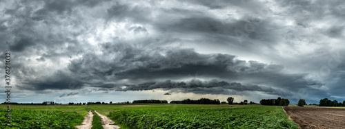 Dark stormy cloud over the fields - panorama