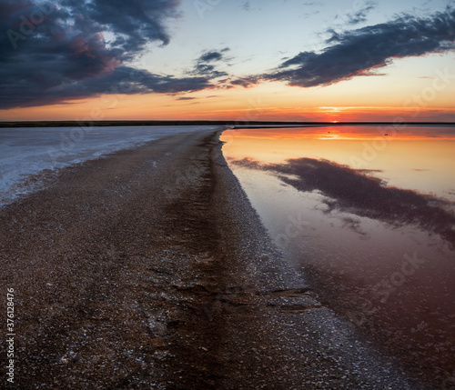 Sunset on the Genichesk pink extremely salty lake  colored by microalgae with crystalline salt depositions   Ukraine.