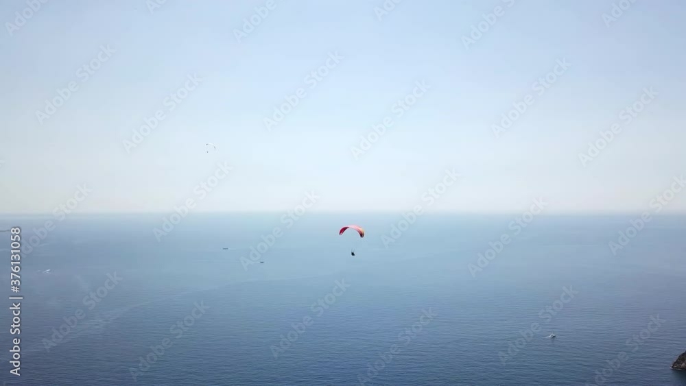 Paragliders flying over sea and beach on resort Paragliders flying over sea and beach on resort