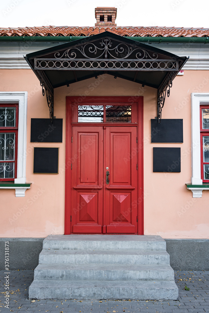 Fototapeta premium Vintage architecture classical facade building with red door
