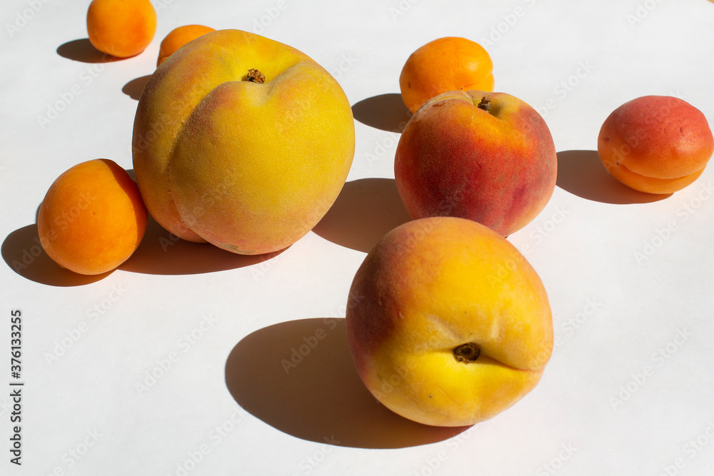 Orange ripe peach and yellow apricot fruit on white background energy vitamin diet concept Orange ripe peach and yellow apricot fruit on white background energy vitamin diet concept
