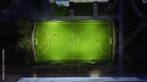Soccer field, evening/night training of soccer team from above aerial view 4k time-lapse photo