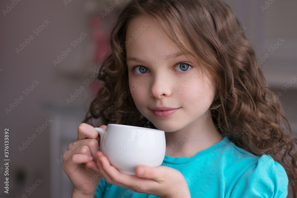 cute little girl sitting by dinner table and eating cute little girl sitting by dinner table and eating