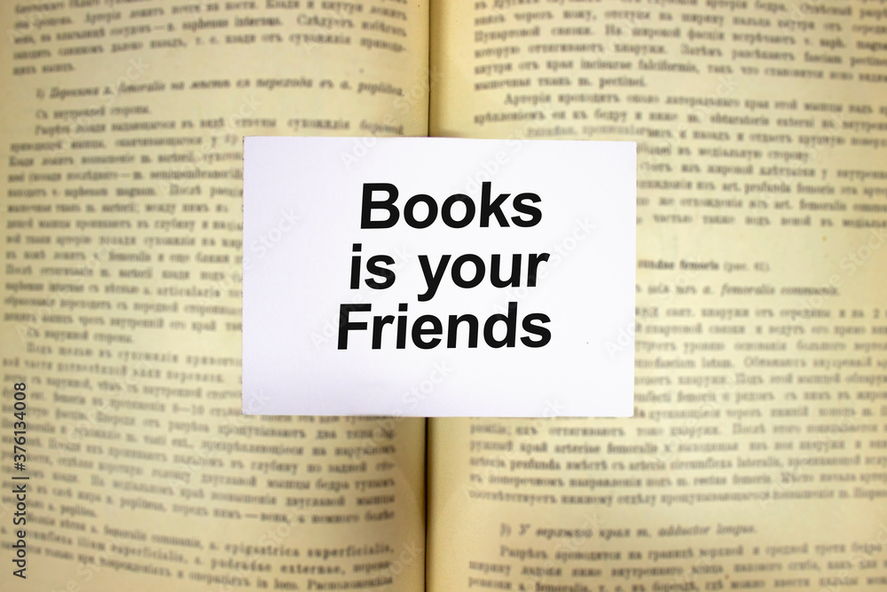Obraz premium Books is youe friends written in white note on open book