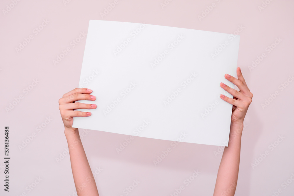 hands hold a white sheet for your inscription on a white background hands hold a white sheet for your inscription on a white background