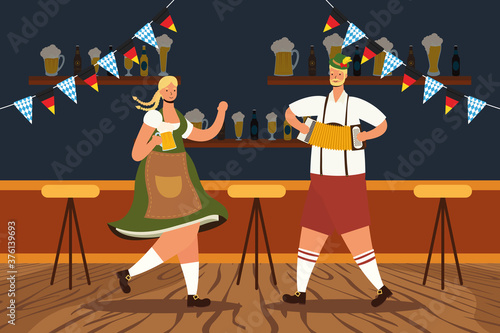 german couple wearing tyrolean suit drinking beers and playing accordion