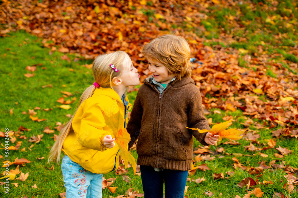 Little girl kissing beautiful little boy outdoor. Children, childhood lifestyle concept. Little girl kissing beautiful little boy outdoor. Children, childhood lifestyle concept.