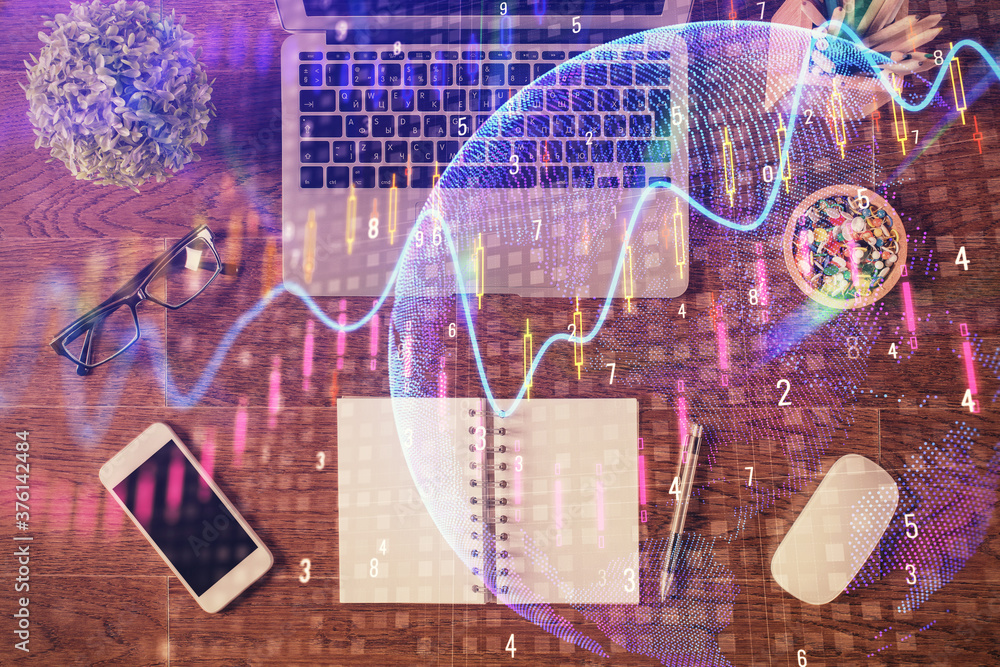 Fototapeta premium Stock market graph and top view computer on the table background. Multi exposure. Concept of financial education.