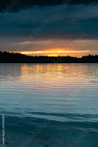 Cloud covered sunrise waterscape over the bay