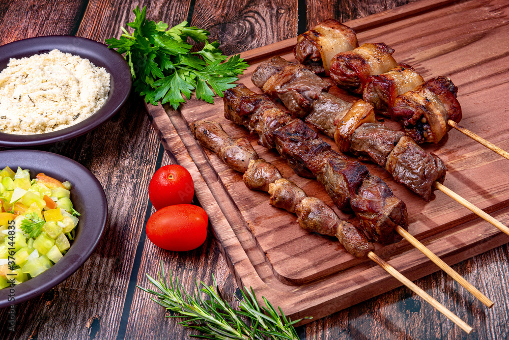 Kebab - Grilled meat on a cutting board, with flour and vinaigrette salad