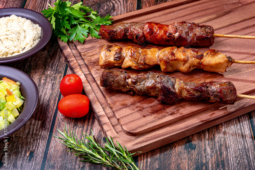 Kebab - Grilled meat on a cutting board, with flour and vinaigrette salad