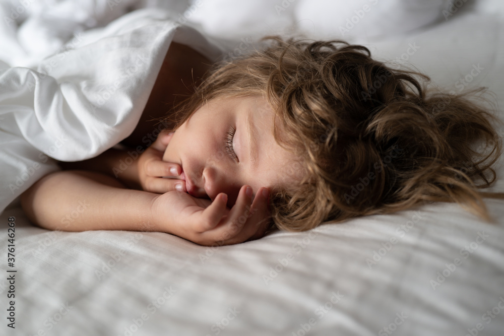 Adorable small kids rest asleep enjoy good healthy peaceful sleep or nap. Six years old Kid sleeping in bed. Adorable small kids rest asleep enjoy good healthy peaceful sleep or nap. Six years old Kid sleeping in bed.