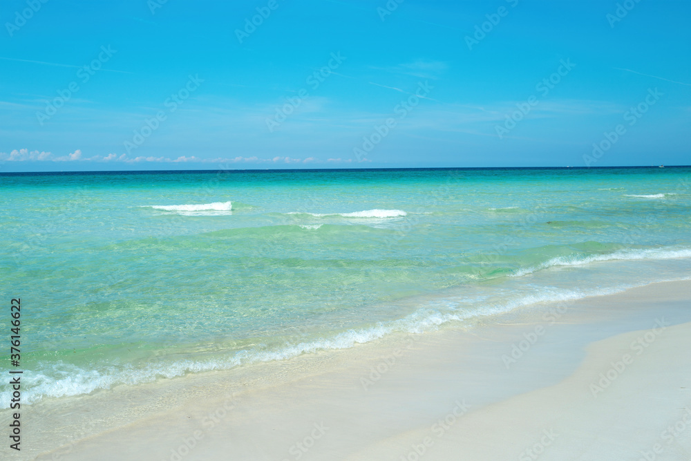 Fototapeta premium Soft blue ocean wave on clean sandy beach.