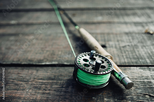 Canvas Print Wallpaper or texture of fly fishing rod lying on old wooden table