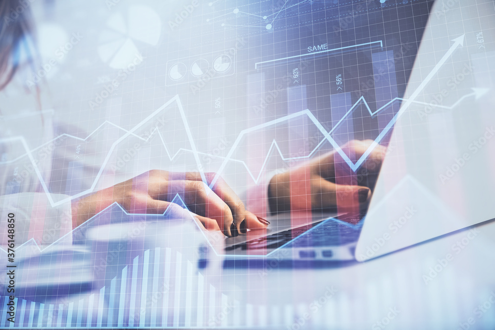 Double exposure of woman hands working on computer and forex graph hologram drawing. Financial analysis concept. Double exposure of woman hands working on computer and forex graph hologram drawing. Financial analysis concept.