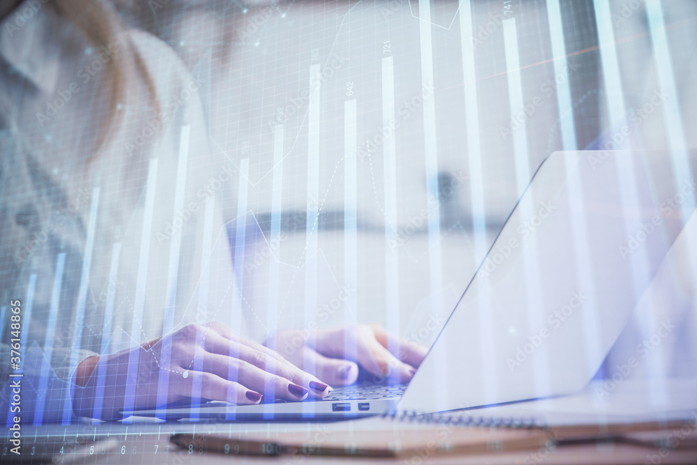 Double exposure of woman hands working on computer and forex graph hologram drawing. Financial analysis concept. Double exposure of woman hands working on computer and forex graph hologram drawing. Financial analysis concept.