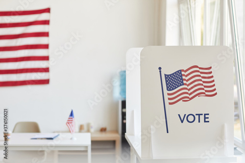 Canvas Print Background image of voting booths decorated with American flags at empty polling
