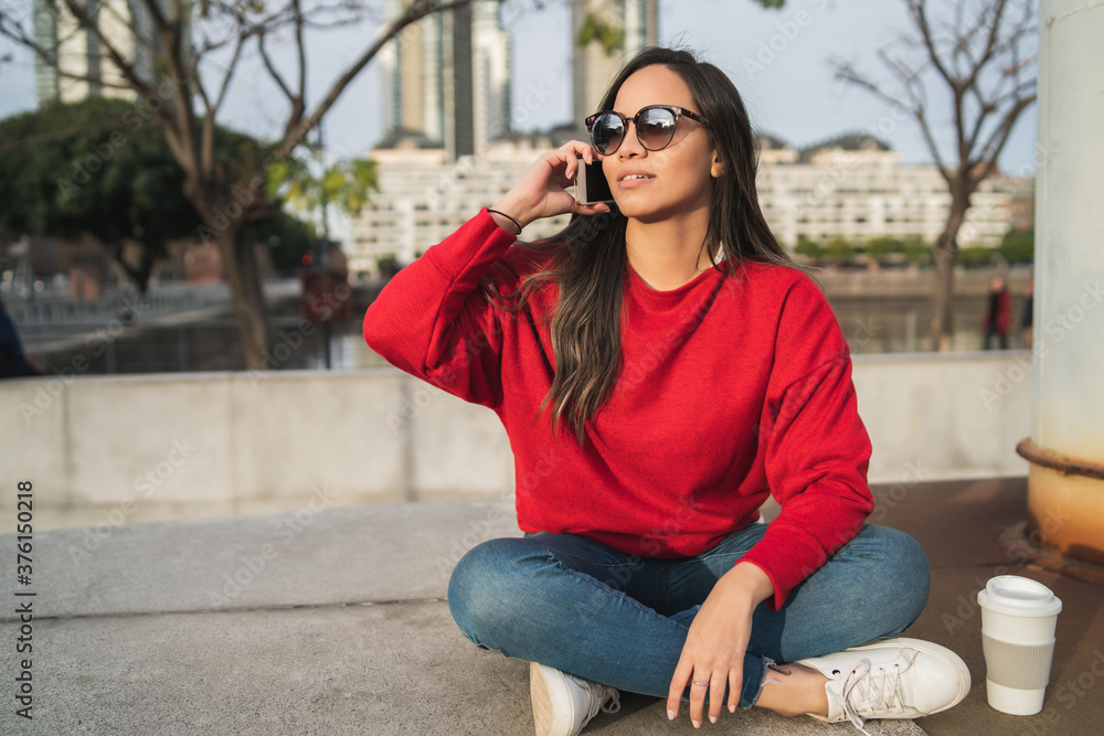 Latin woman talking on the phone. Latin woman talking on the phone.