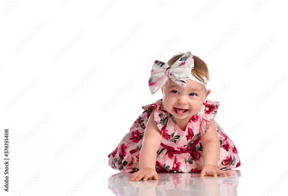 Happy little baby girl in dress crawling on floor Happy little baby girl in dress crawling on floor