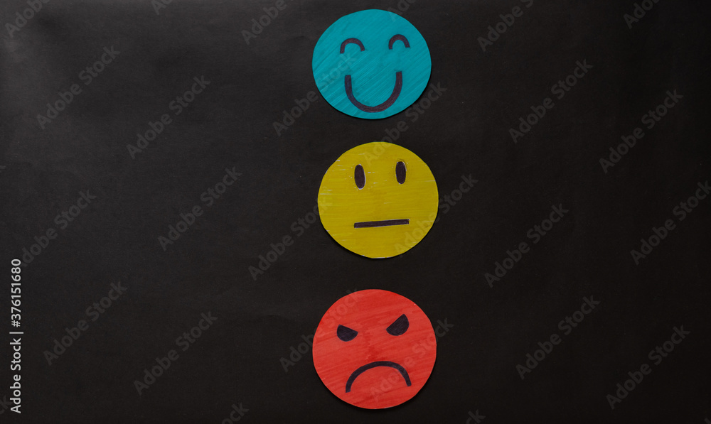 Hand choosing green paper cut happy smile face, feedback rating and positive customer review, experience, satisfaction survey, mental health evaluation concept Hand choosing green paper cut happy smile face, feedback rating and positive customer review, experience, satisfaction survey, mental health evaluation concept