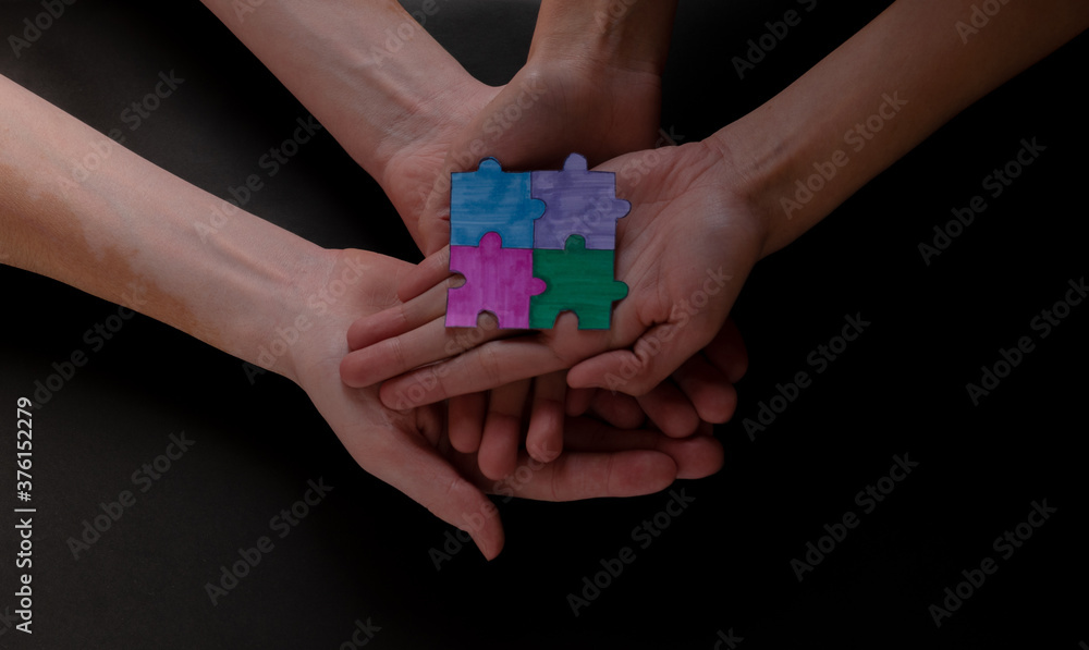 Hands with puzzle pieces, business strategy planning, Alzheimer's disease, autism and mental health, social distancing concept