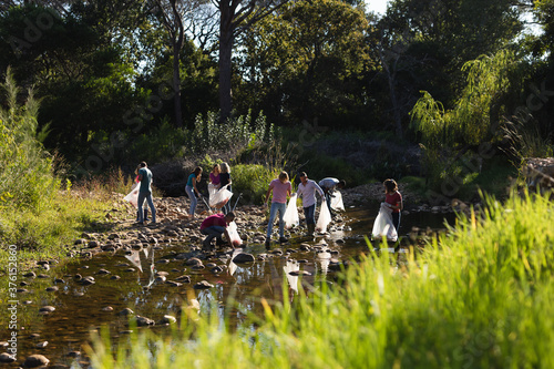 Volunteers cleaning up river in the countryside photo